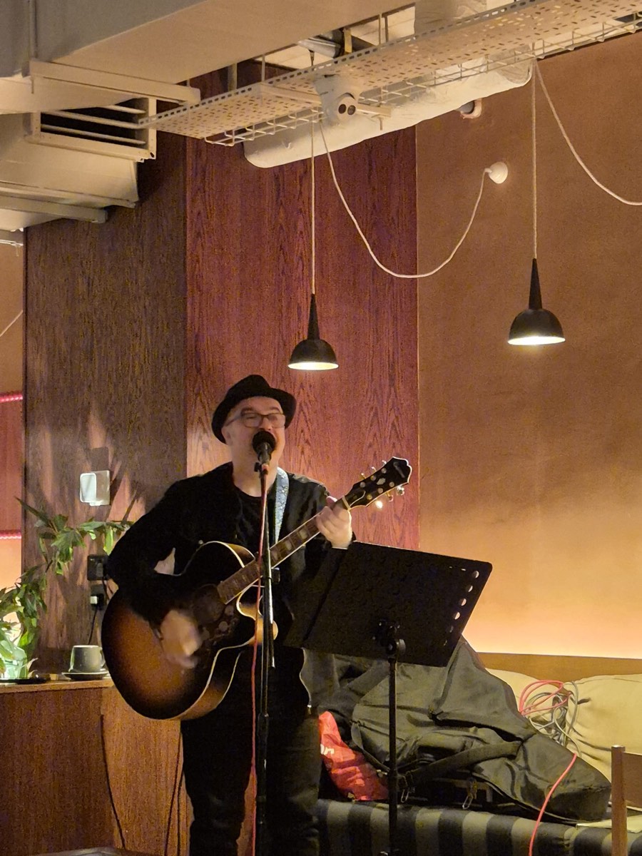 Edwin Addis performing with a guitar