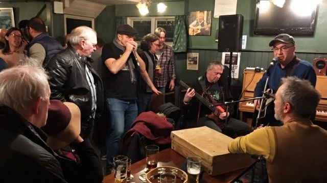 Musicians and community members gathered for an indoor open mic session